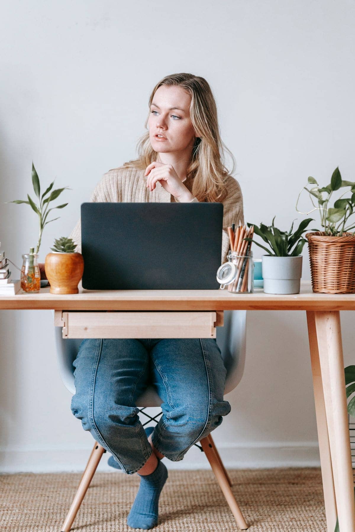 Freelancer working at a home desk with a laptop