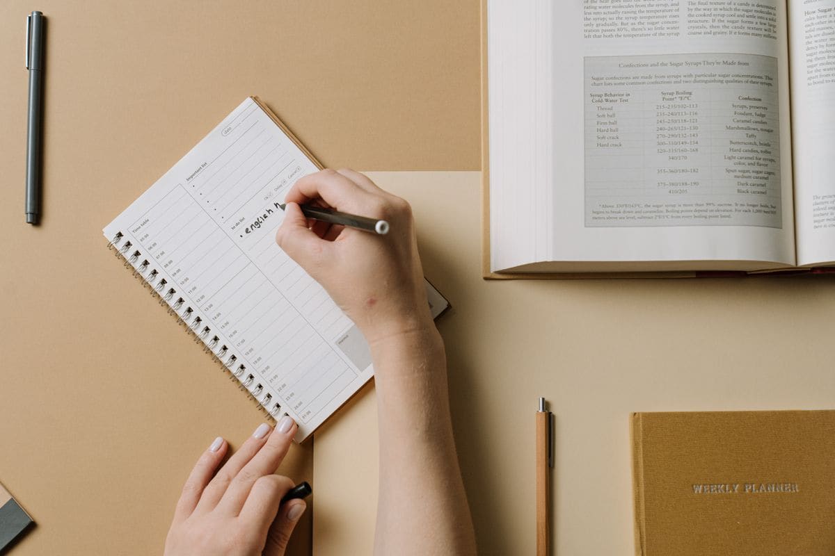 Person writing on a calendar