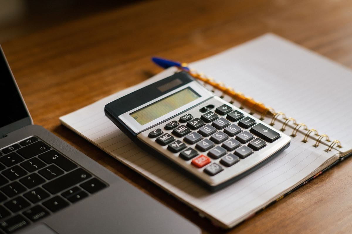 Accountant table with bills, glasses and a calculator