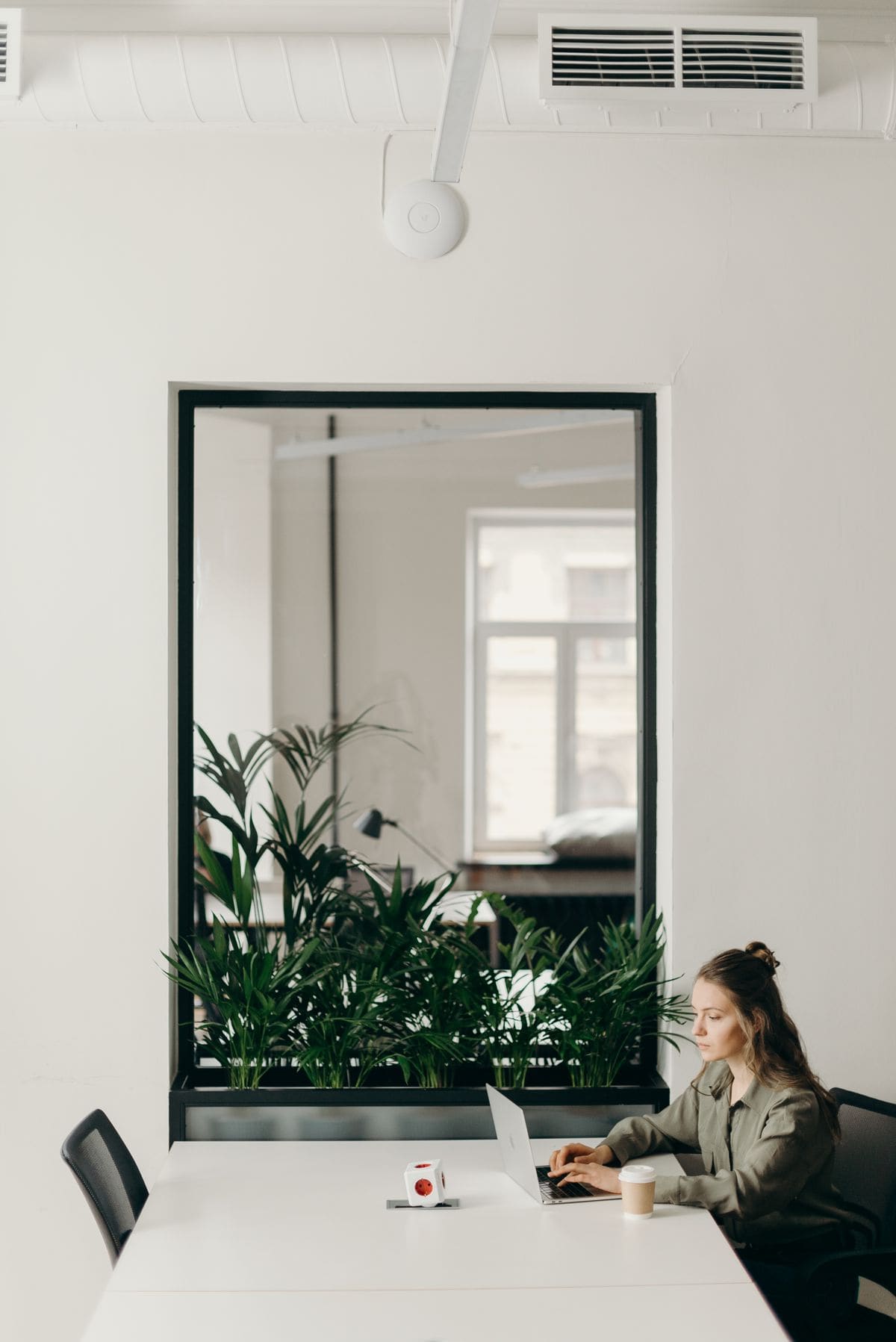 Woman working on a laptop in a minimal modern office