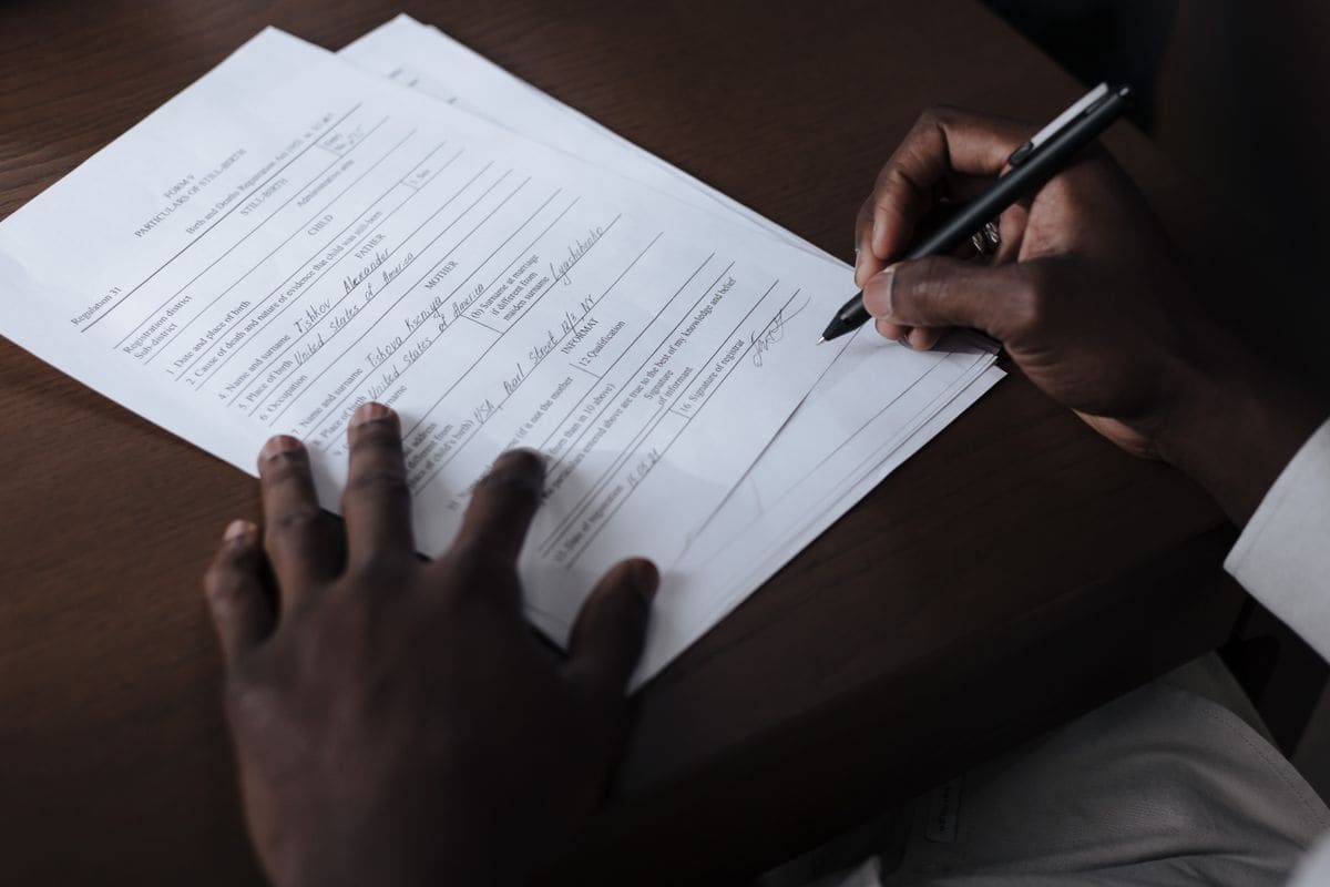Man signing a paper at a desk